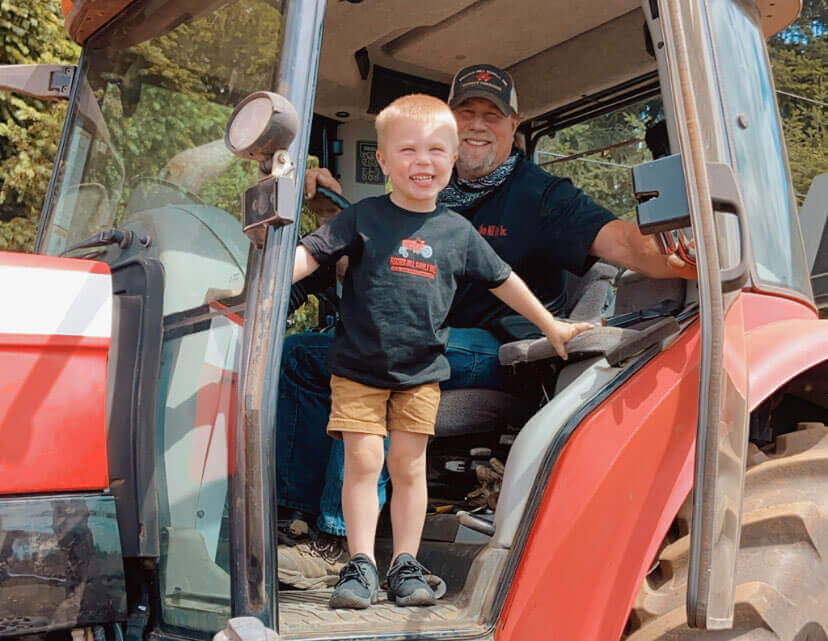 kid smiling in tractor