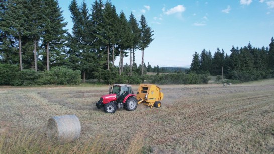 Massey Ferguson tractor and hay baler operating in a field near Oregon City, Oregon